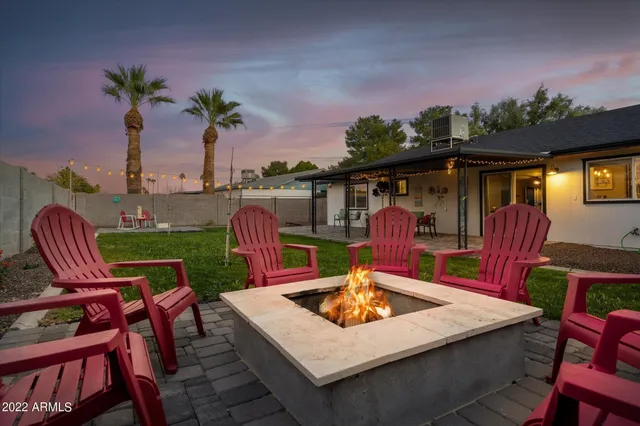 a view of a patio with a table chairs and a potted plant
