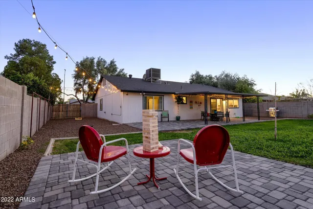 a patio with table and chairs