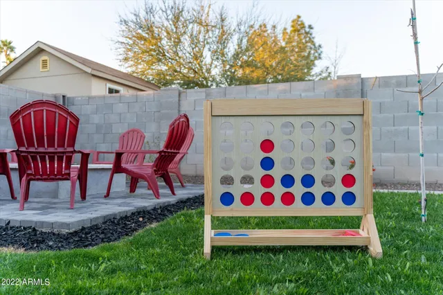 a view of backyard with seating and trees