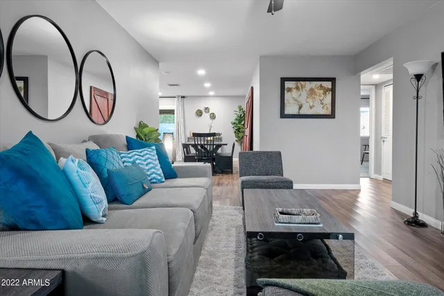 a living room with furniture and a mirror