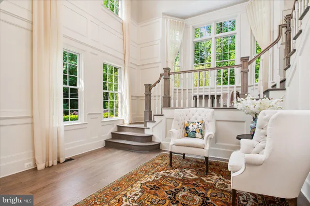 a living room with furniture a fireplace and a large window