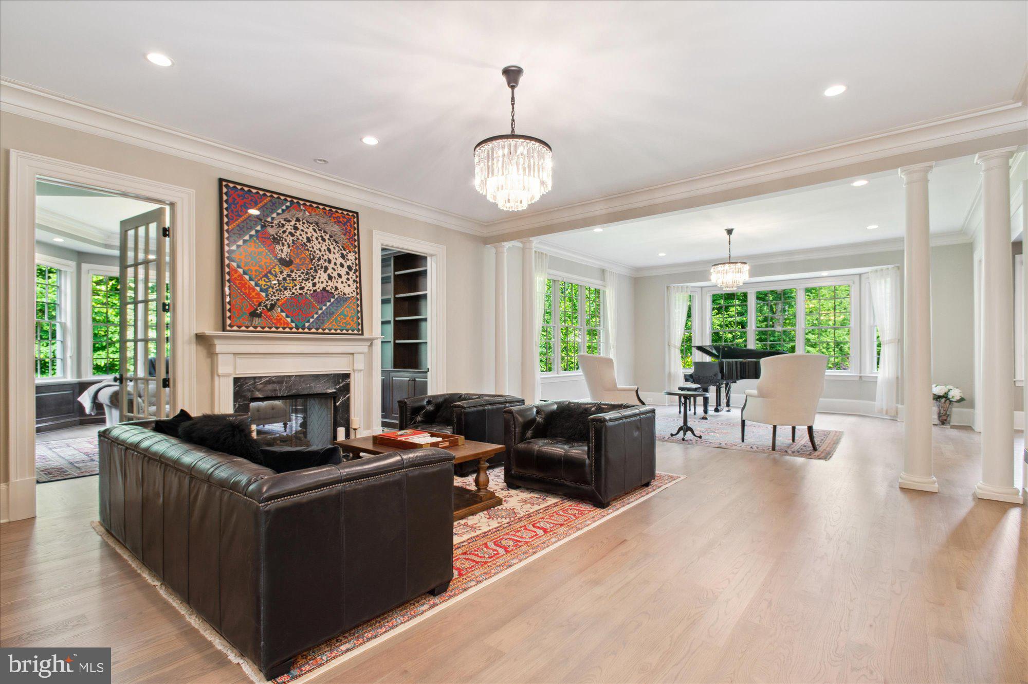 6804 Benjamin Street McLean, VA 22101 - Photo 19 of 68 a living room with furniture a fireplace and a large window