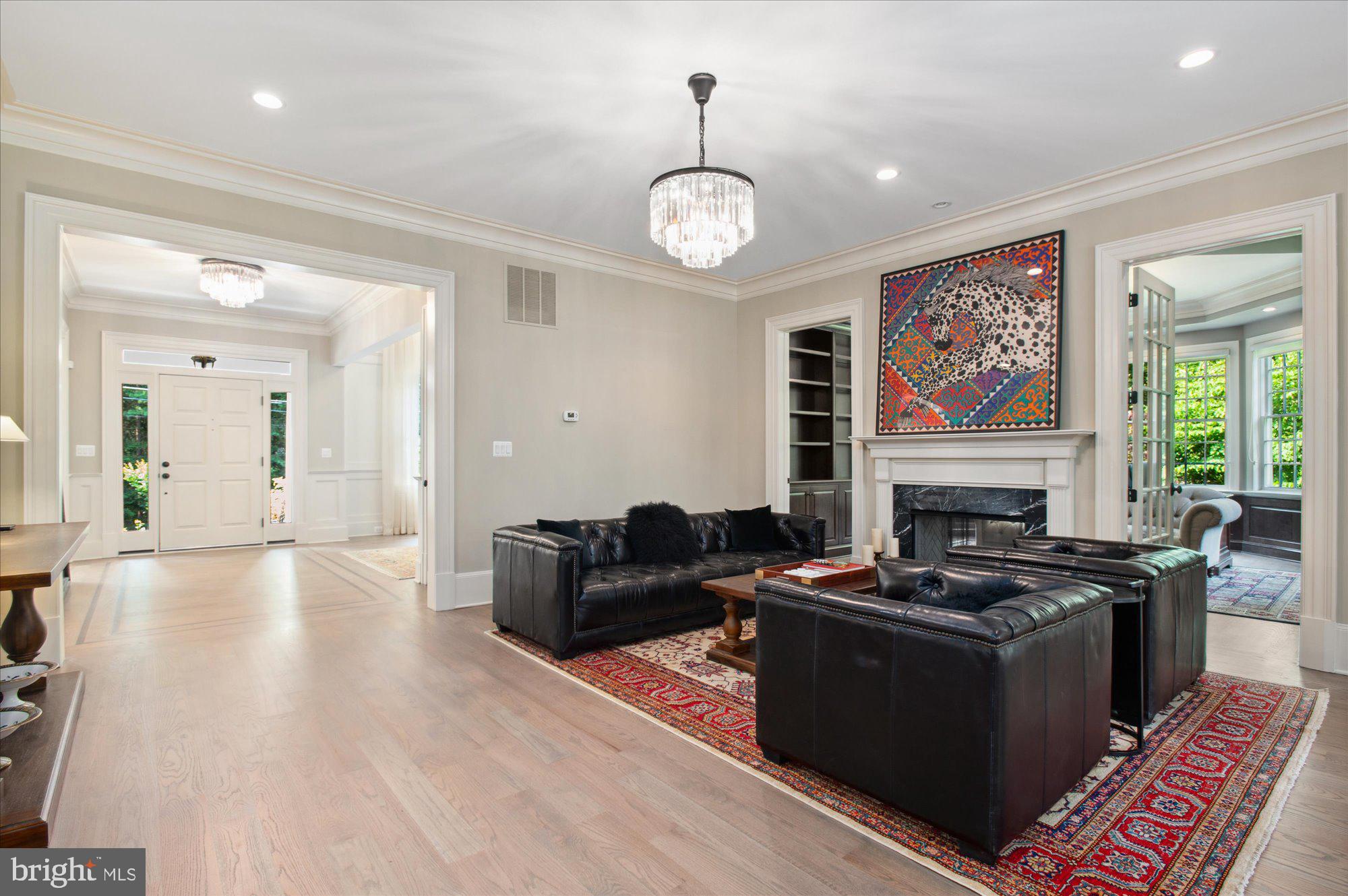 6804 Benjamin Street McLean, VA 22101 - Photo 20 of 68 a living room with furniture a fireplace and a large window