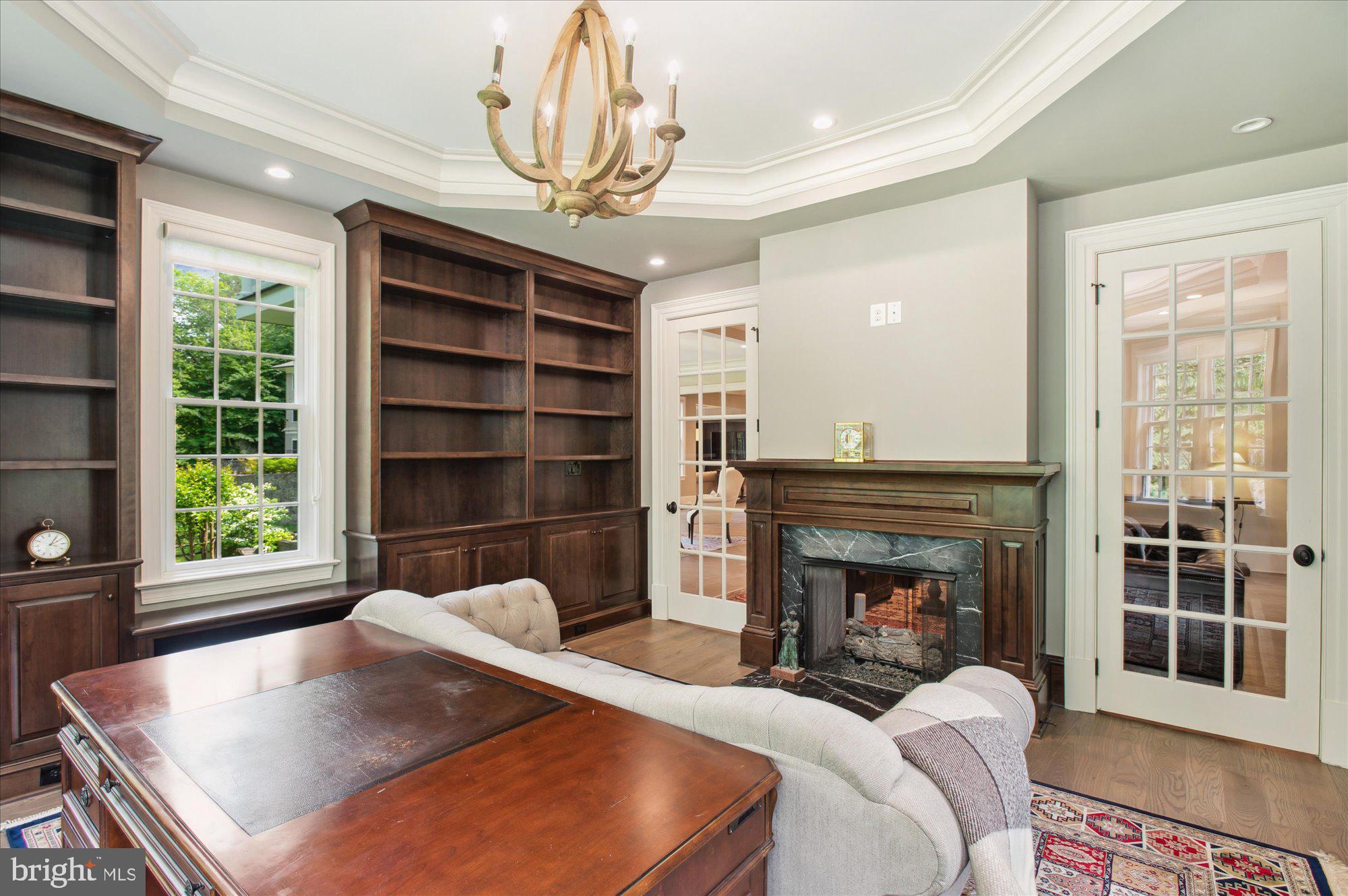 6804 Benjamin Street McLean, VA 22101 - Photo 22 of 68 a living room with furniture and a fireplace