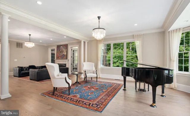 a living room with furniture fireplace and a large window