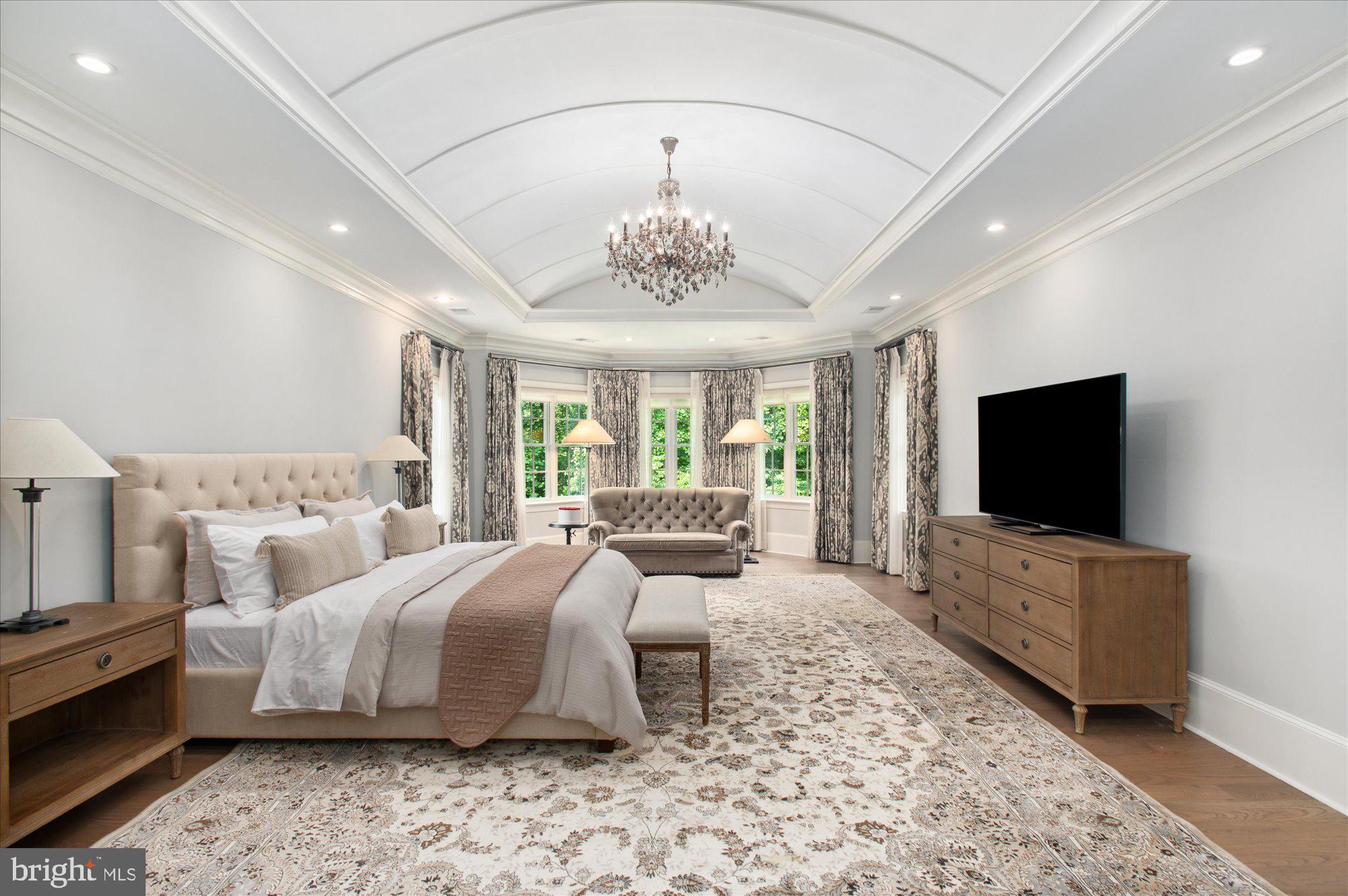 6804 Benjamin Street McLean, VA 22101 - Photo 39 of 68 a spacious bedroom with a bed and a flat screen tv