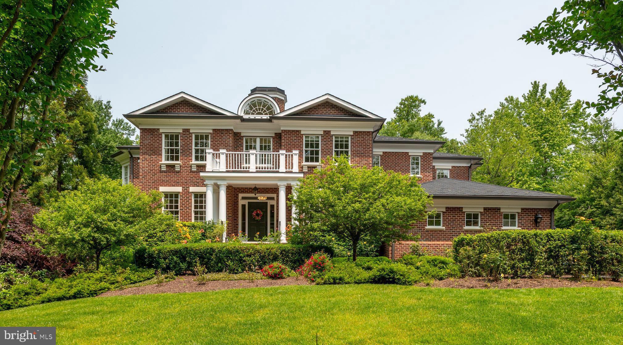 6804 Benjamin Street McLean, VA 22101 - Photo 43 of 68 a front view of a house with a yard and green space
