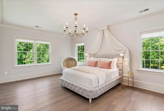 a view of a brick house with a big yard and large trees