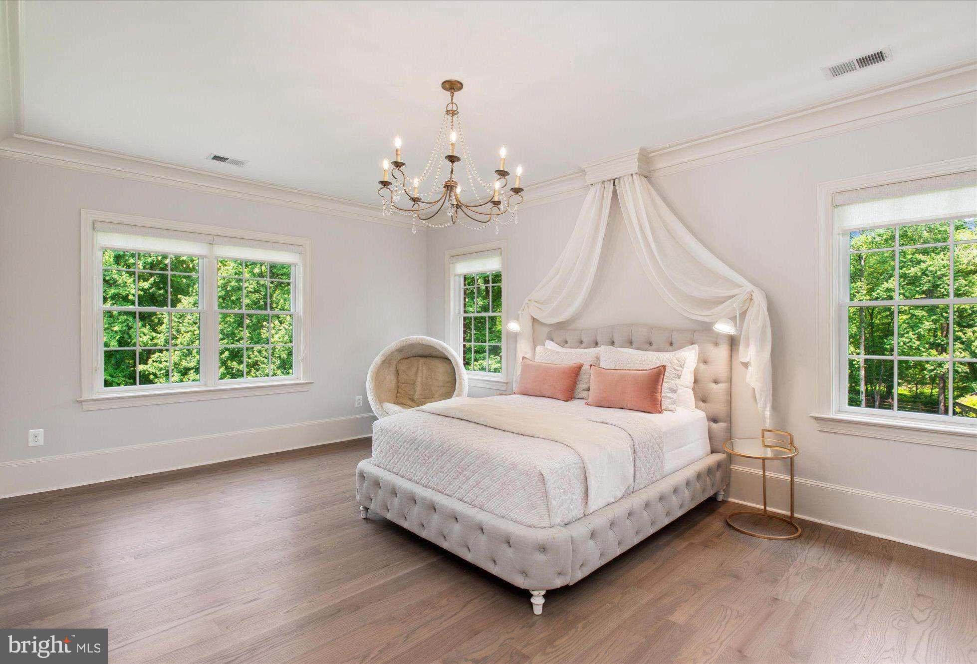6804 Benjamin Street McLean, VA 22101 - Photo 47 of 68 a bedroom with a bed chandelier and window