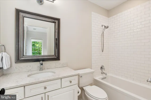 a view of a grassy field with trees in the background