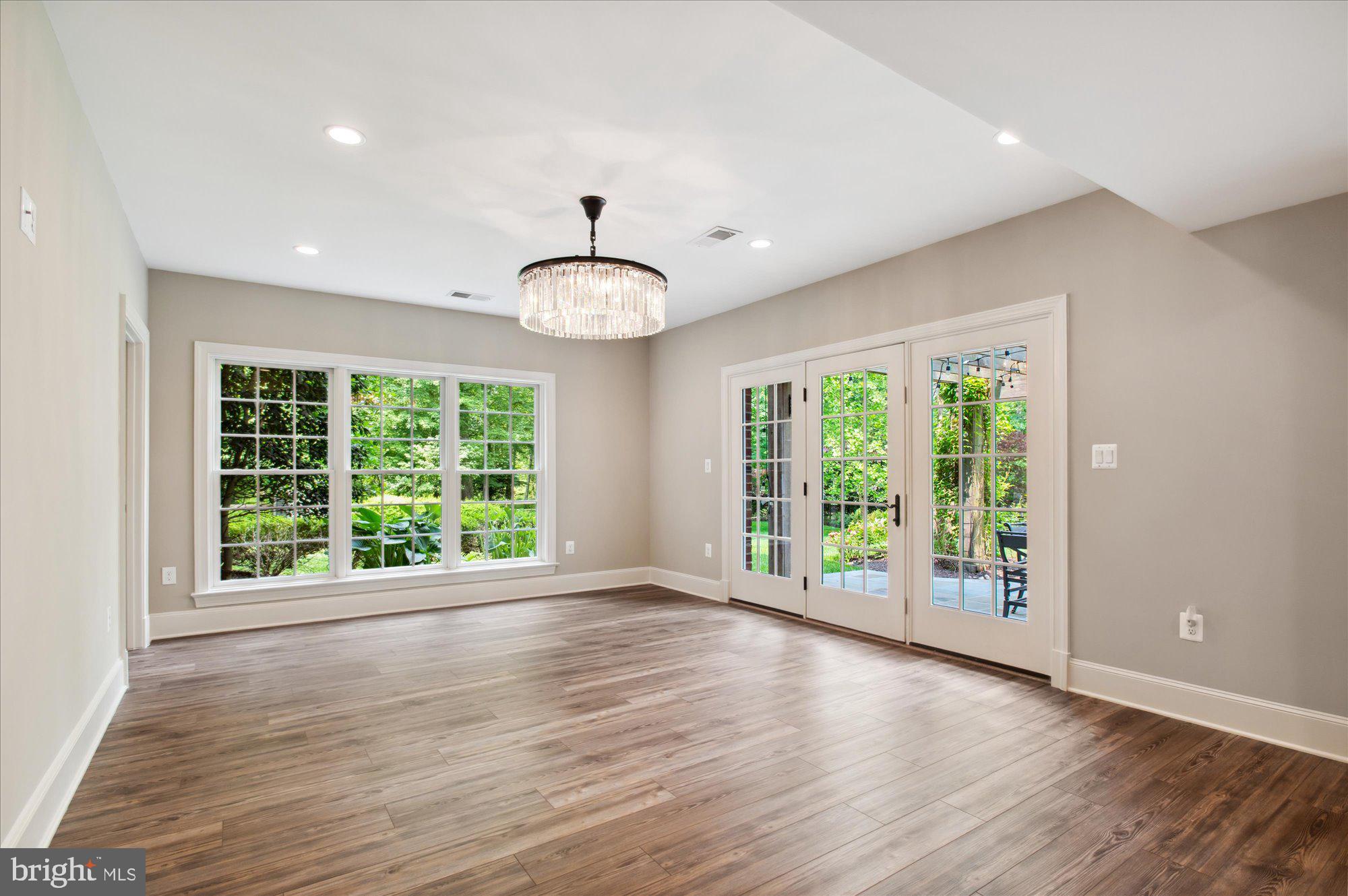 6804 Benjamin Street McLean, VA 22101 - Photo 62 of 68 a view of an empty room with wooden floor and a window