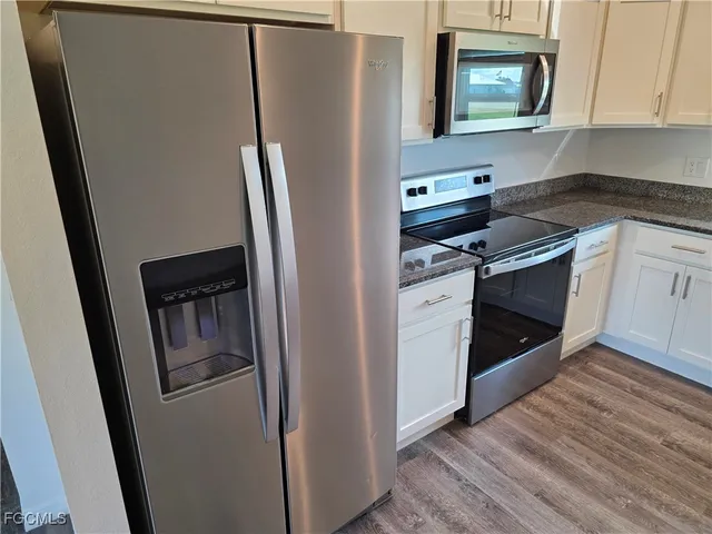 a kitchen with stainless steel appliances a refrigerator stove and microwave