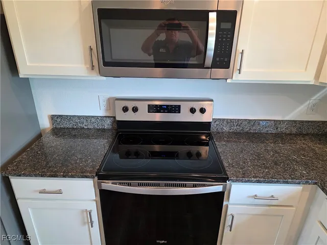 a stove top oven sitting inside of a kitchen
