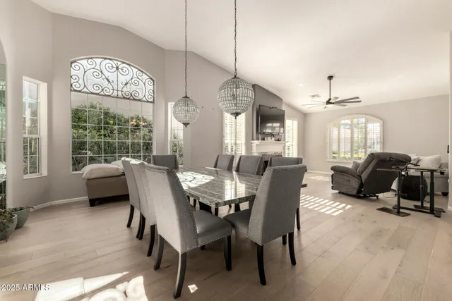 a view of a dining room with furniture a chandelier and wooden floor