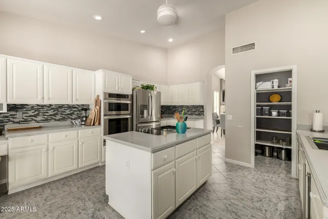 a kitchen that has a lot of cabinets in it and appliances