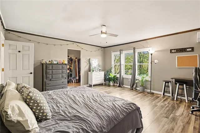 a bed room with a bed a dresser and a large mirror