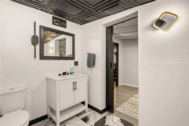 a bathroom with a sink toilet and shower