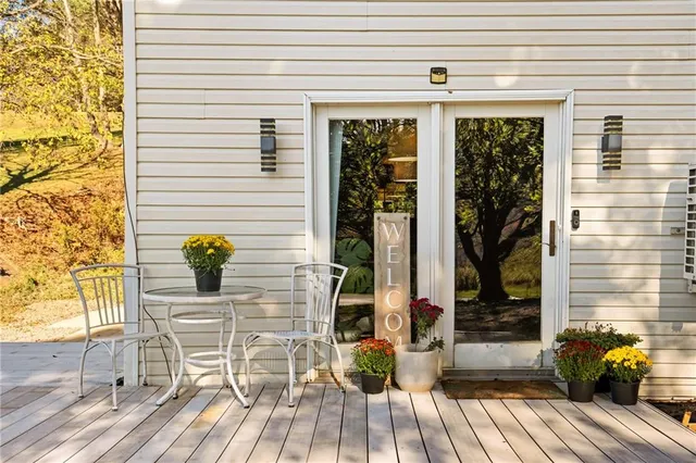 a view of balcony with two chairs and wooden floor
