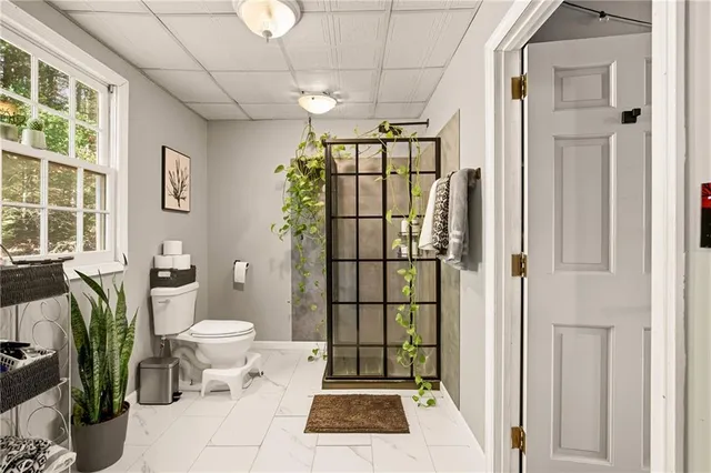 a bathroom with a toilet a sink and shower