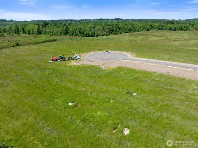 a view of a field with an ocean