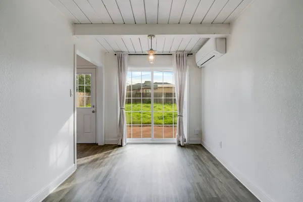 a view of a room with wooden floor and natural light