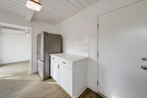 a view of a kitchen with refrigerator and sink