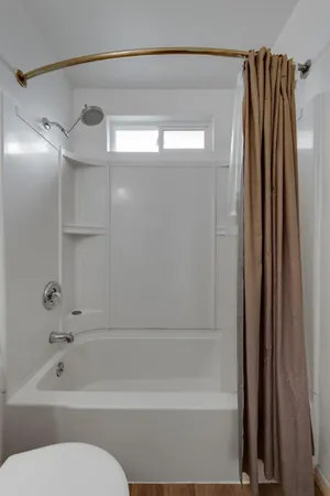 a bathroom with a shower and a toilet