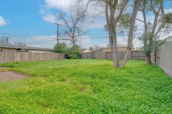 a view of a house with a yard and sitting area