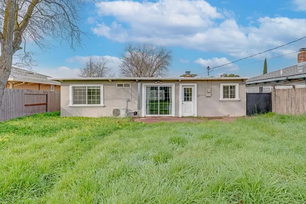 a view of backyard of house with green space