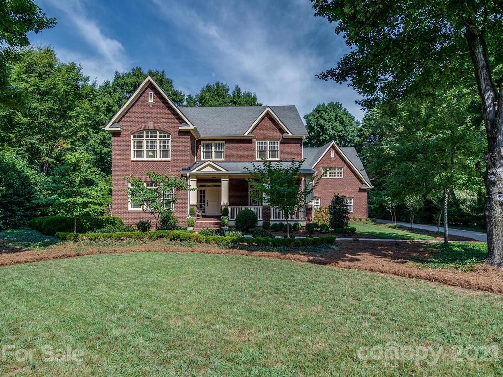 4608 Nora's Path Road Charlotte, NC 28226 - Photo 1 of 39 a front view of a house with a yard and trees