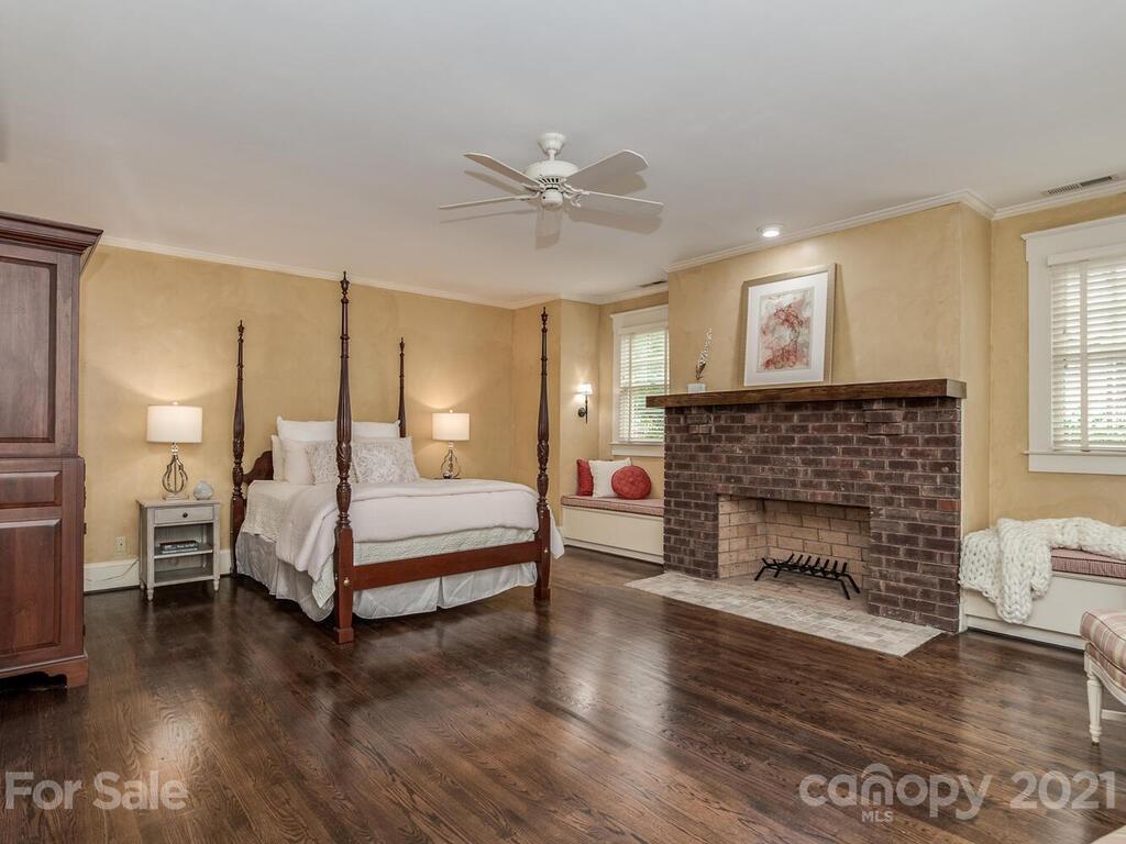 4608 Nora's Path Road Charlotte, NC 28226 - Photo 20 of 39 a bedroom with a bed and a fireplace
