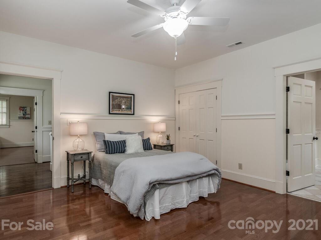 4608 Nora's Path Road Charlotte, NC 28226 - Photo 25 of 39 a bedroom with a bed and a chandelier