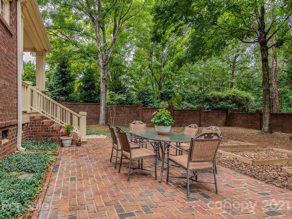 4608 Nora's Path Road Charlotte, NC 28226 - Photo 32 of 39 a patio with table and chairs and potted plants