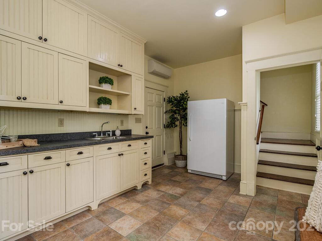 4608 Nora's Path Road Charlotte, NC 28226 - Photo 36 of 39 a kitchen with granite countertop white cabinets and refrigerator