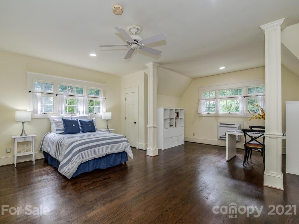 4608 Nora's Path Road Charlotte, NC 28226 - Photo 37 of 39 a spacious bedroom with a bed and a table in it