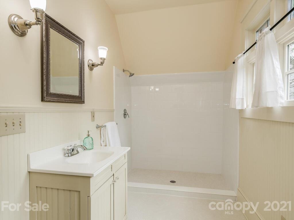 4608 Nora's Path Road Charlotte, NC 28226 - Photo 39 of 39 a bathroom with a sink a mirror and a shower
