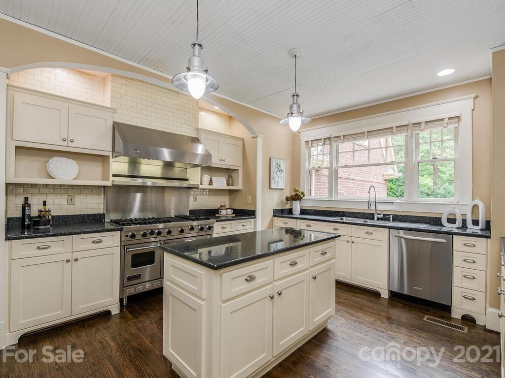 4608 Nora's Path Road Charlotte, NC 28226 - Photo 10 of 39 a kitchen with stainless steel appliances granite countertop a stove a sink and white cabinets