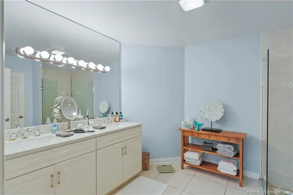 a bathroom with a mirror sink and shower