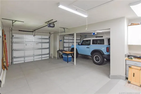 a view of a room with furniture and a chandelier