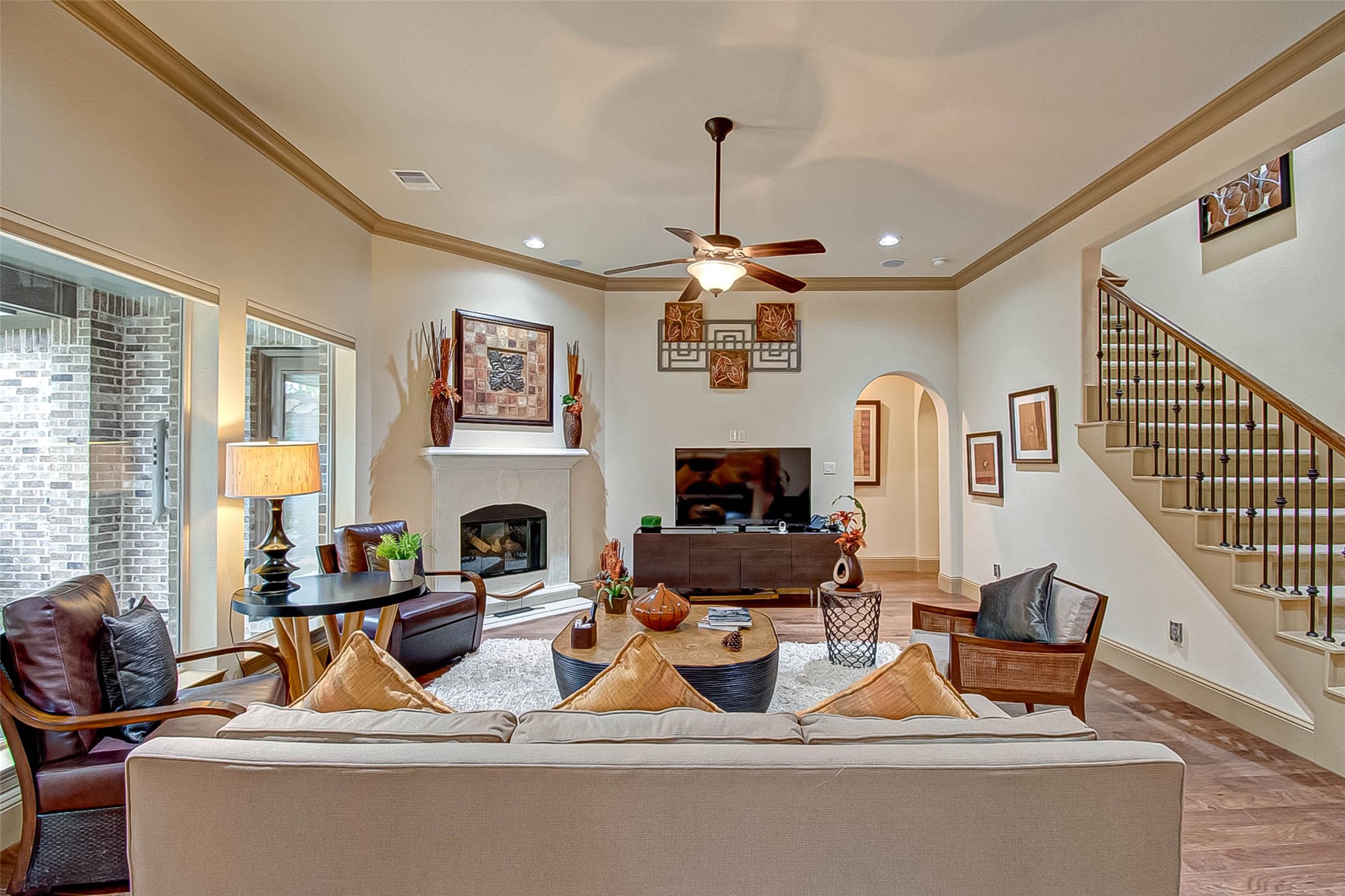 7 Shearling Court Spring, TX 77389 - Photo 12 of 46 a living room with furniture a fireplace and a flat screen tv