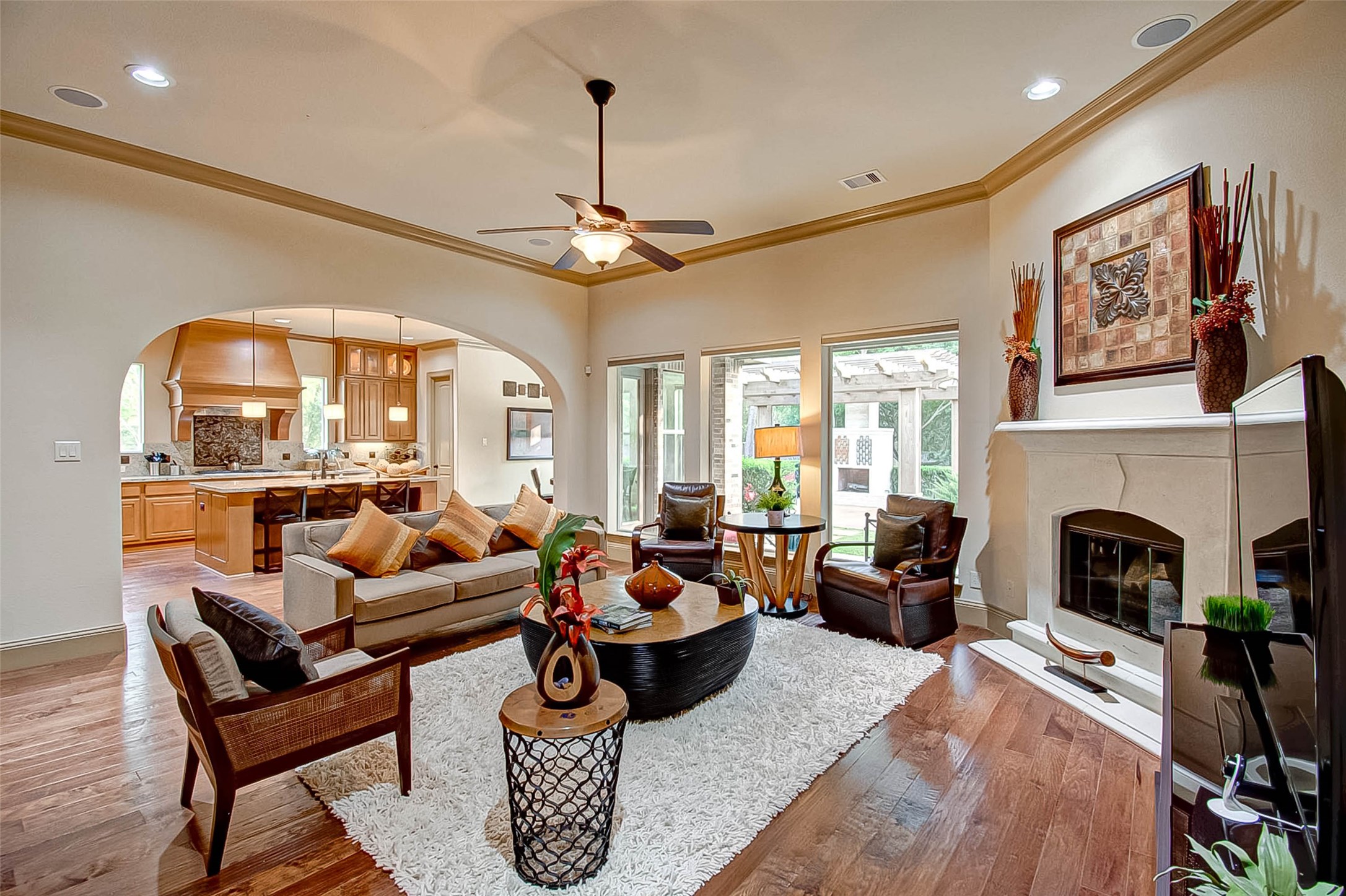 7 Shearling Court Spring, TX 77389 - Photo 13 of 46 a living room with furniture a fireplace and a chandelier