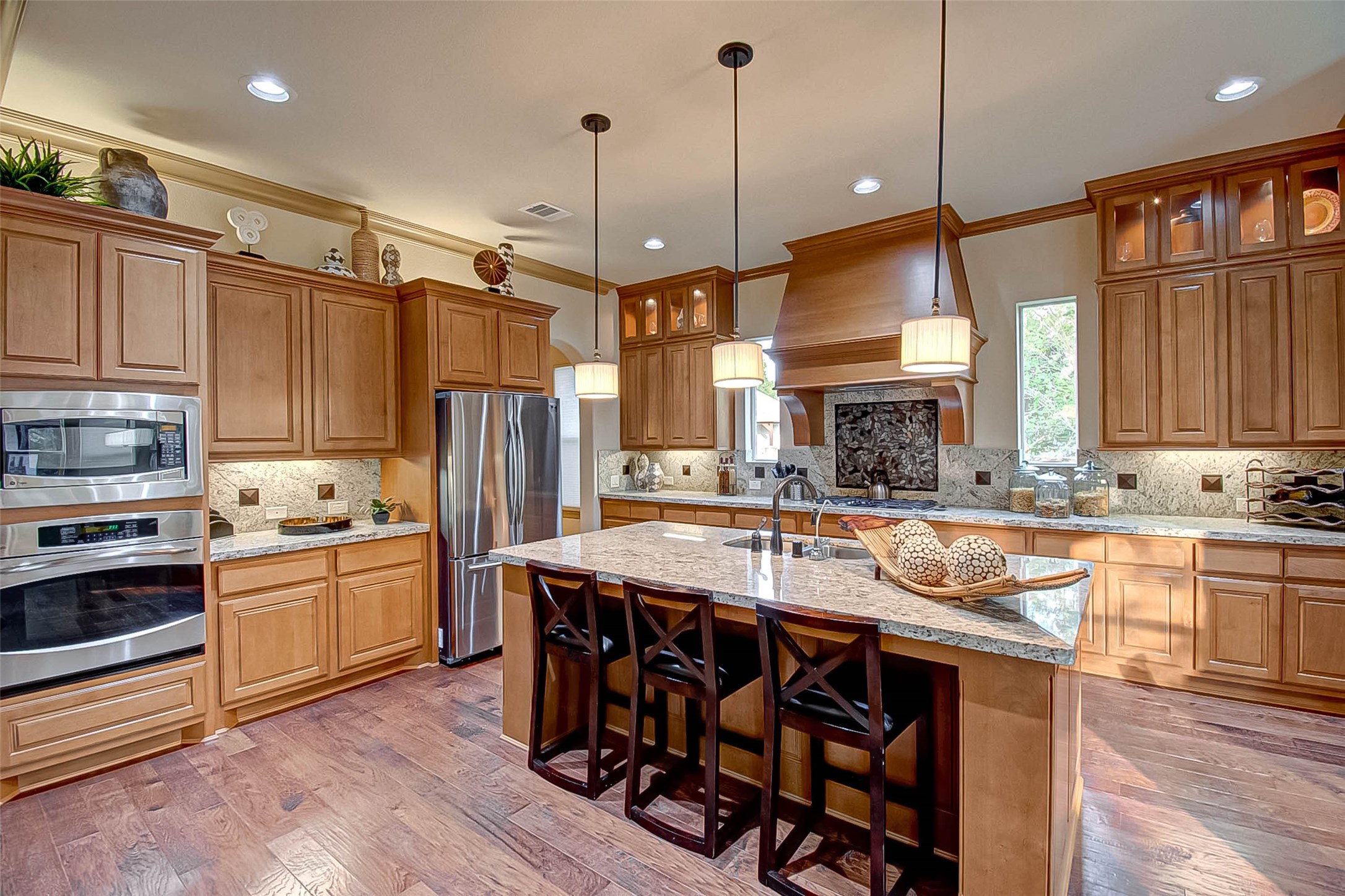 7 Shearling Court Spring, TX 77389 - Photo 14 of 46 a kitchen with stainless steel appliances granite countertop a stove a sink dishwasher a refrigerator and a dining table with wooden floor
