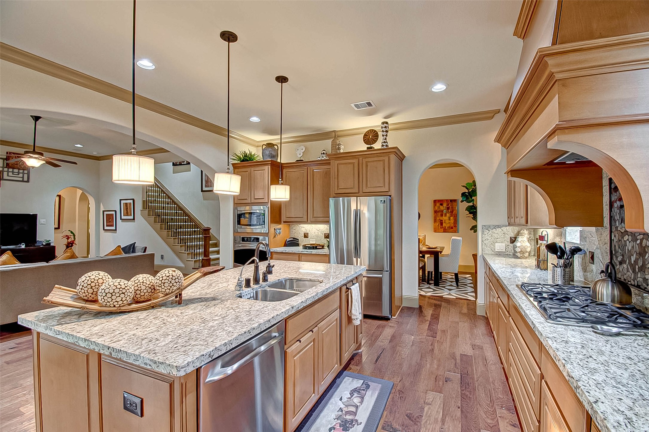 7 Shearling Court Spring, TX 77389 - Photo 18 of 46 a kitchen with stainless steel appliances granite countertop a sink a counter space appliances and cabinets