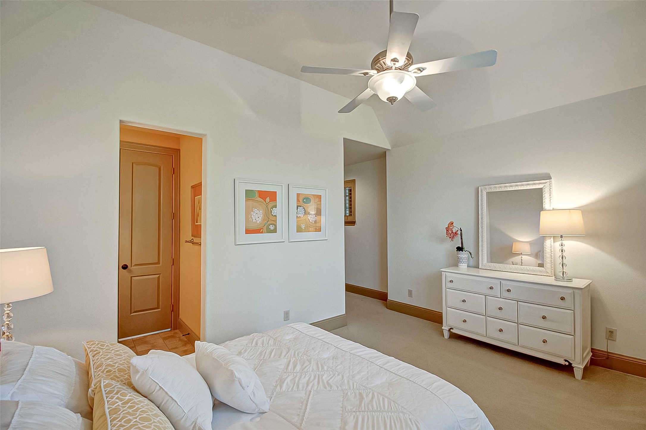 7 Shearling Court Spring, TX 77389 - Photo 24 of 46 a bedroom with a bed and a chandelier