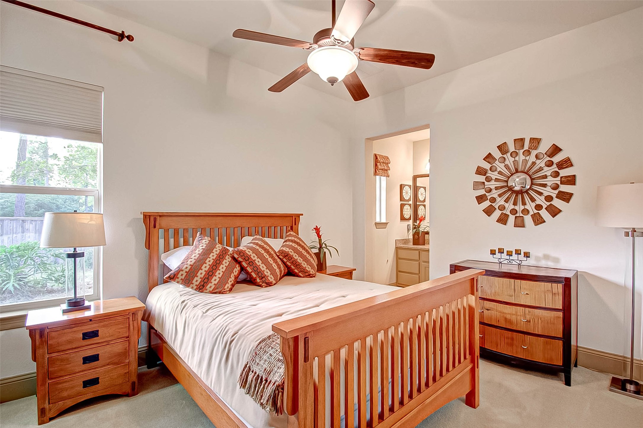 7 Shearling Court Spring, TX 77389 - Photo 27 of 46 a bedroom with a bed and a chandelier