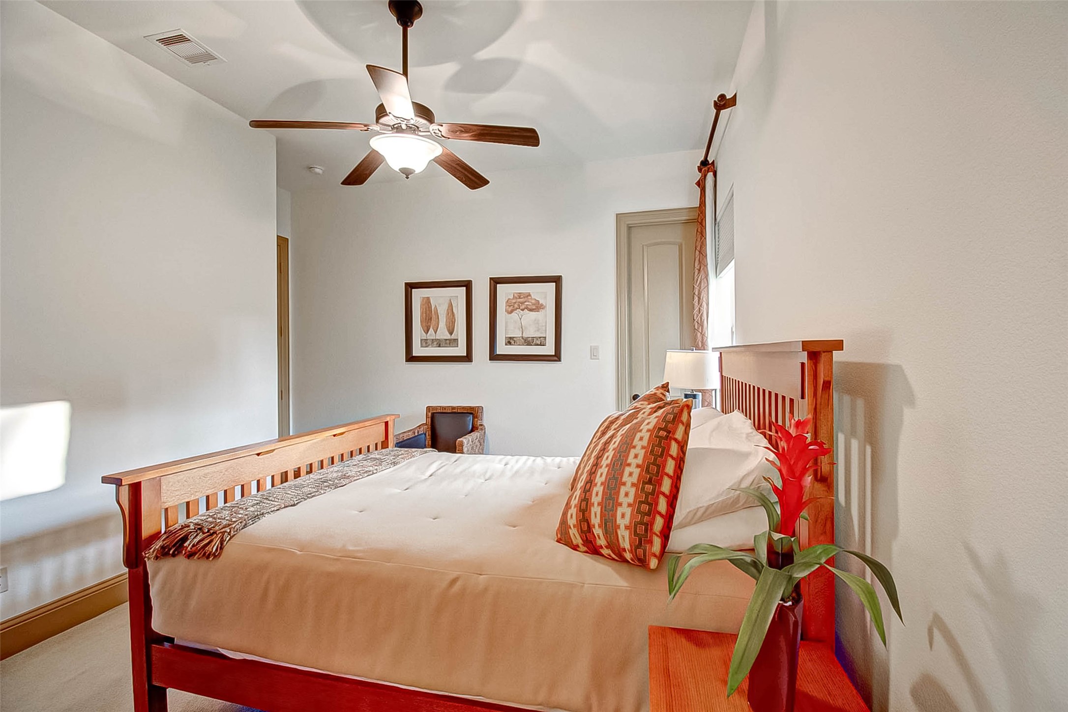 7 Shearling Court Spring, TX 77389 - Photo 28 of 46 a bedroom with a bed and a chandelier