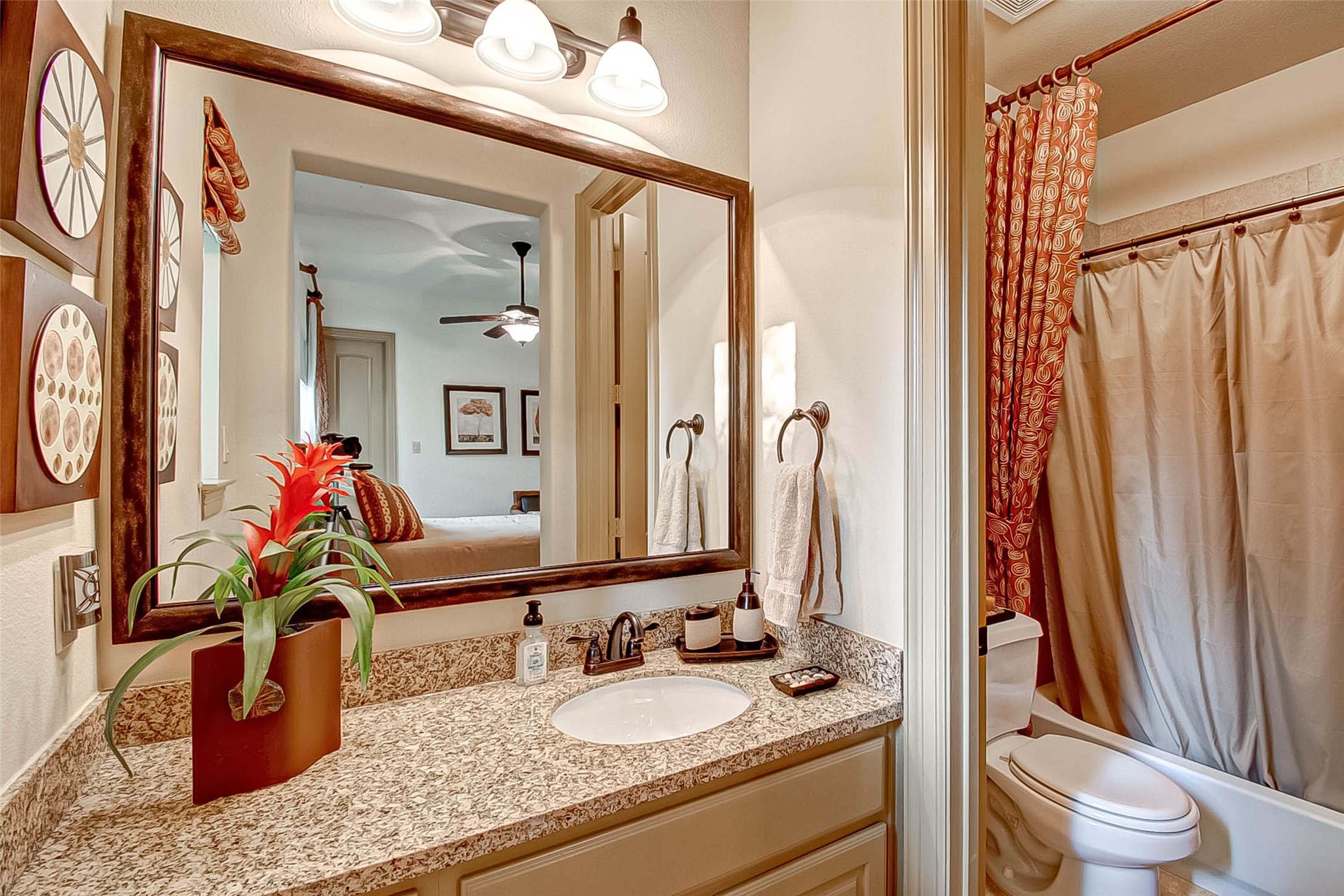 7 Shearling Court Spring, TX 77389 - Photo 29 of 46 a bathroom with a granite countertop sink and a mirror