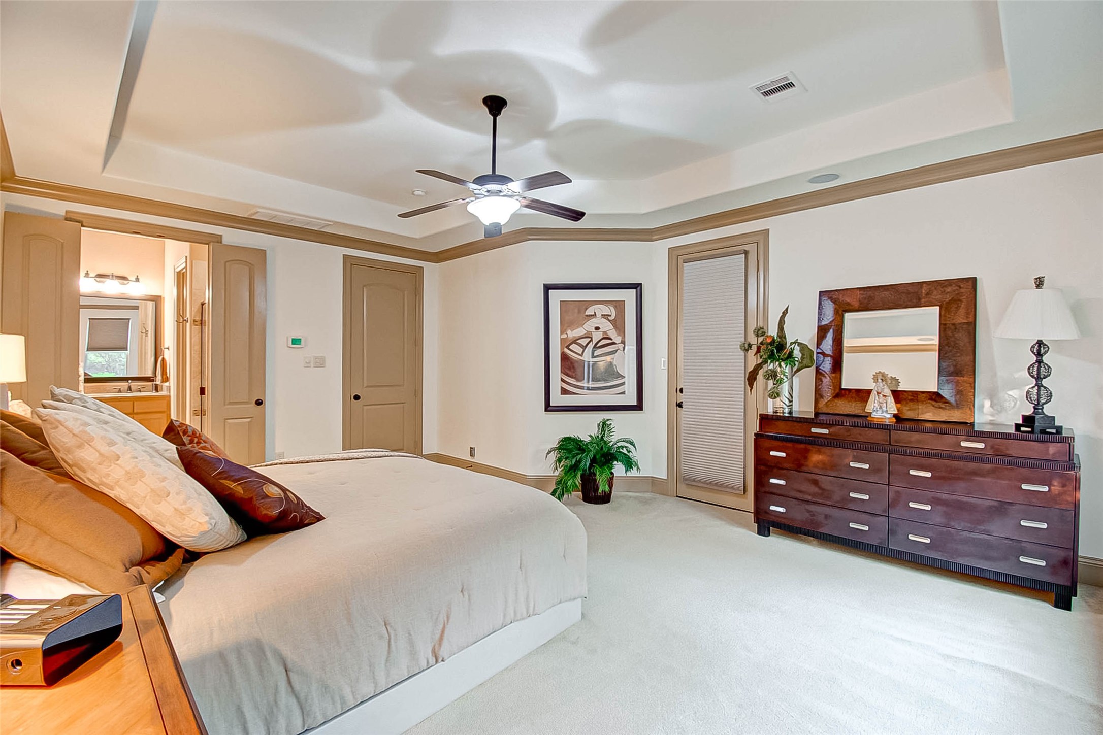 7 Shearling Court Spring, TX 77389 - Photo 32 of 46 a spacious bedroom with a bed and a dresser