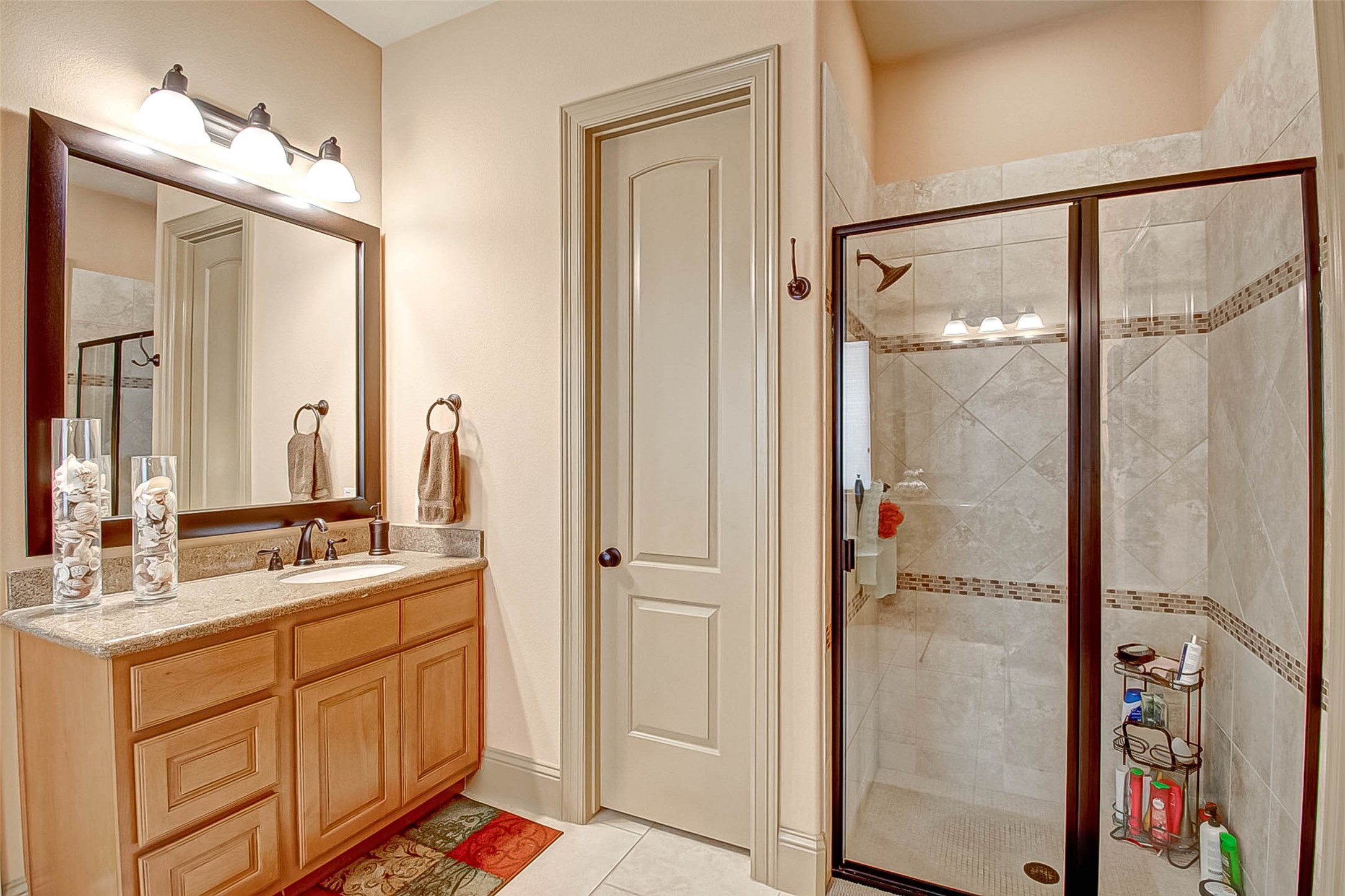 7 Shearling Court Spring, TX 77389 - Photo 36 of 46 a bathroom with a double vanity sink a mirror and a shower