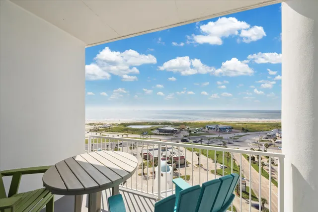 a view of a balcony with chair and table